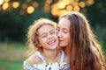 Two Cute little girls hugging and laughing at the countryside. Happy kids spending time outdoors