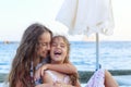 Two beautiful Little Girls hugging and smiling at the Seaside at  Summer Sunny Day, Ocean Coast, happy Kids concept Royalty Free Stock Photo