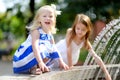 Two cute little girls playing with a city fountain on hot summer day Royalty Free Stock Photo