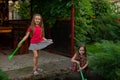 Two cute little girls playing with a city fountain on hot and sunny summer day. Two little girls in the summer Royalty Free Stock Photo