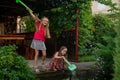 Two cute little girls playing with a city fountain on hot and sunny summer day. Two little girls in the summer Royalty Free Stock Photo