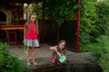 Two cute little girls playing with a city fountain on hot and sunny summer day. Two little girls in the summer Royalty Free Stock Photo