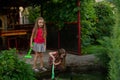 Two cute little girls playing with a city fountain on hot and sunny summer day. Two little girls in the summer Royalty Free Stock Photo