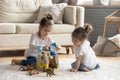 Two cute little girls playing on warm floor together Royalty Free Stock Photo