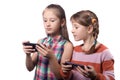 Two cute little girls posing with mobile phones Royalty Free Stock Photo