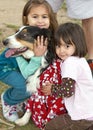 Two cute little girls and a rescue agency dog Royalty Free Stock Photo