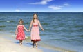 Two cute little girls walking on the beach Royalty Free Stock Photo