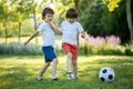 Two cute little kids, playing football together, summertime. Chi Royalty Free Stock Photo