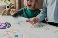 Two little girls are painting on the table. Kids are sisters or classmates. Royalty Free Stock Photo
