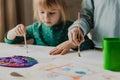 Two little girls are painting on the table. Kids are sisters or classmates. Royalty Free Stock Photo