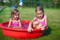 Two cute little sisters frolicing and splashing in Royalty Free Stock Photo