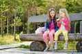 Two cute little sisters having fun during forest hike on beautiful summer day Royalty Free Stock Photo