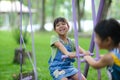 Two cute little sisters having fun playing in the playground during summer. Adorable little girl rocking a horse in a playground Royalty Free Stock Photo
