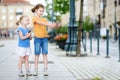 Two cute little sisters playing outdoor mobile game on their smart phones Royalty Free Stock Photo