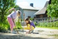 Two cute little sisters playing in a puddle on beautiful summer day outdoors. Royalty Free Stock Photo