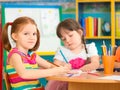 Two cute preschool girls at drawing lesson