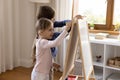 Two cute sibling kids drawing on toy small childish whiteboard Royalty Free Stock Photo