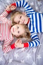 Two cute siblings lying on bed. Fokus frome above