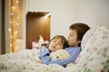 Two cute sick children, boys, staying in bed with fever Royalty Free Stock Photo