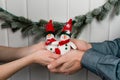 two cute toy snowmen in male and female hands Royalty Free Stock Photo