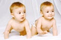Two cute twins baby on the bed