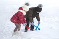 Two cute young children in warm clothing with bright snow clips Royalty Free Stock Photo