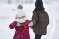 Two cute young children in warm clothing with bright snow clips Royalty Free Stock Photo