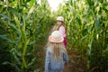 Two cute young girls having fun in a corn maze field during autumn season. Games and entertainment during harvest time Royalty Free Stock Photo