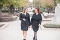 Two cute young girls are walking and talking about important topics. Royalty Free Stock Photo