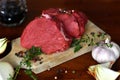 Two cuts of fresh raw beef steak on the wooden cutting board