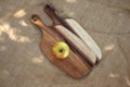 Two cutting boards with a yellow apple