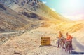 Two cyclist standing on mountains road. Himalayas, Jammu and Kashmir State, North India