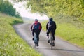 Two cyclists on a country lane. Royalty Free Stock Photo