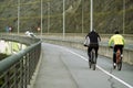 Two cyclists dressed for sport pedaling with cars near by Royalty Free Stock Photo