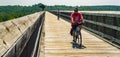 Two Cyclists enjoying a day riding their bicycles on the High Bridge Trail State Park located in Farmville, Cumberland County, Vir