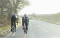 Two Cyclists Racing On Busy Country Road Lake District England 1st December 2017