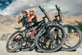 Two cyclists rest on the mountain road