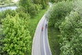 Two cyclists ride bikes on bicycle path in city park. aerial photography with drone Royalty Free Stock Photo