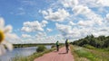 two cyclists riding on the road in the park Royalty Free Stock Photo