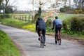 Two cyclists riding together on an english countryside road Royalty Free Stock Photo