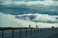 Two cyclists on a road in Iceland with beautiful cloudy sky behind Royalty Free Stock Photo