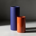 Ylindrical vases are placed side by side on a surface illuminat Royalty Free Stock Photo