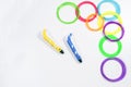 Two 3d printing pens and colorful filaments on white background. Top view Royalty Free Stock Photo