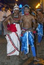 Two dancers dressed in traditional Sri Lankan costumes wait for the commencement of the Esala Perahera in Kandy, Sri Lanka.