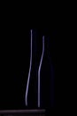 Two dark blue bottles on a black background Royalty Free Stock Photo