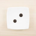 The two dark chocolate buttons and small white square disk Royalty Free Stock Photo