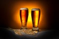 two dark glass frothy beer with ears of wheat on light background, Oktoberfest concept Royalty Free Stock Photo