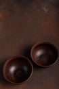 Two dark handmade clay bowls on dark background