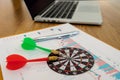 Two darts aiming at the target center of dart board onthe table, Setting challenging trading  goals And ready to achieve Royalty Free Stock Photo