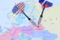 Two darts with flags of usa and russia hitting Belarus on world map close-up Royalty Free Stock Photo